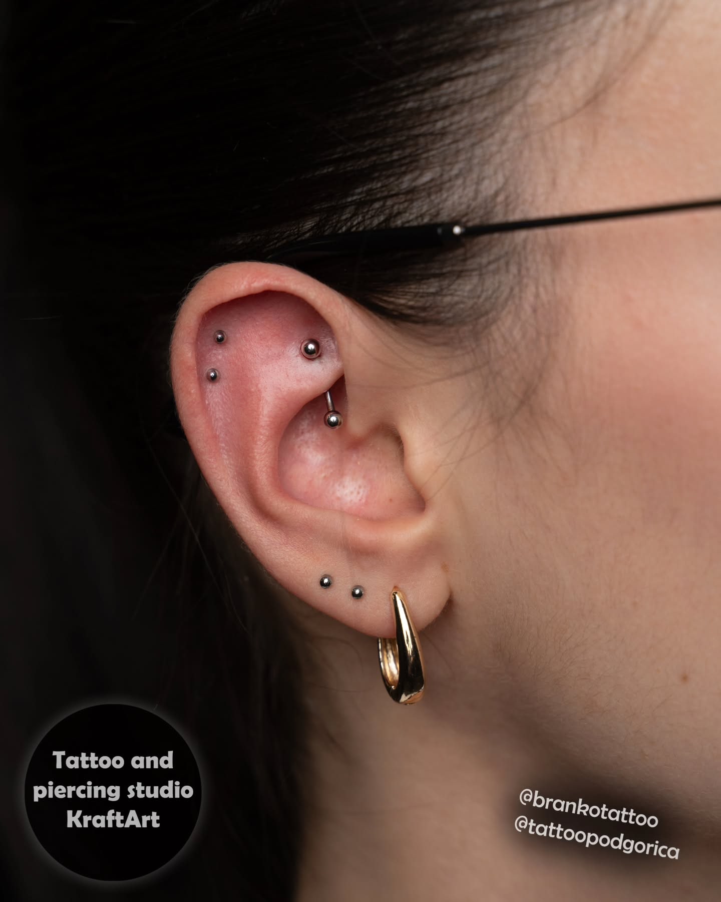 Piercing na uhu — dvije helix pozicije i lobe sa zlatnim nakitom